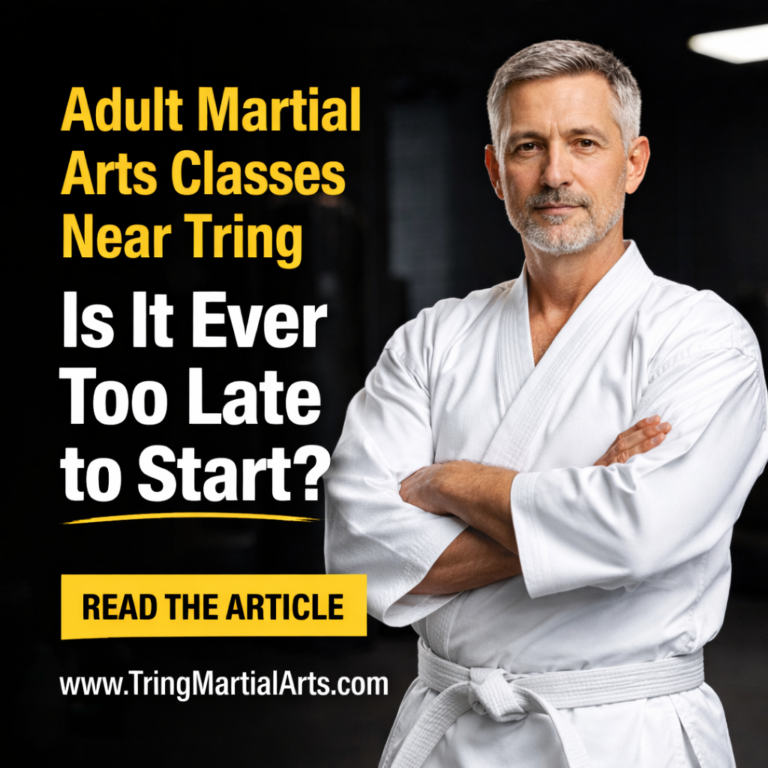 Middle-aged man wearing a white martial arts uniform and white belt, standing confidently in a dojo, promoting adult martial arts classes near Tring.